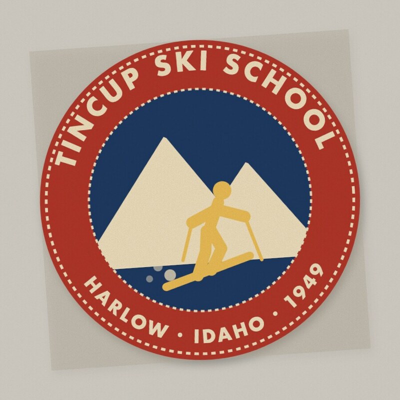 Round felt patch: red border reading Tincup Ski School, Harlow, Idaho, 1949, around a navy center with cream mountains and a gold skier.