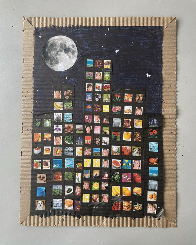 Collage of a city skyline at night on cardboard: black paper buildings with hundreds of tiny windows cut from colorful magazine photos under a navy sky and a magazine-photo moon.