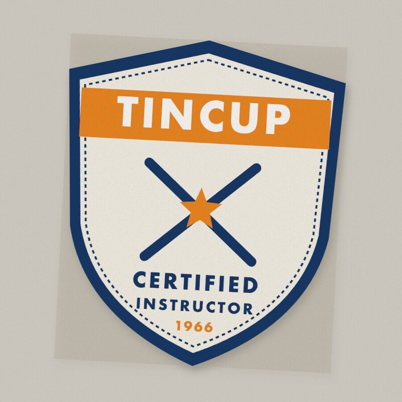 Shield-shaped patch with a navy border: orange banner reading Tincup, crossed skis with an orange star, and Certified Instructor 1966.
