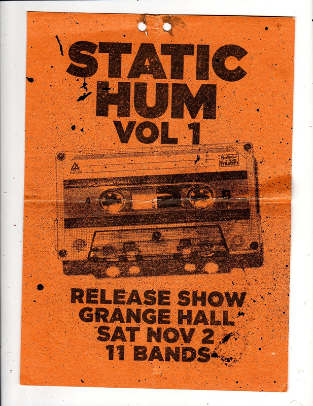 Flyer on orange paper: a halftone photo of a cassette tape and big letters for the Static Hum Vol. 1 release show at the Grange Hall, Saturday November 2, eleven bands.