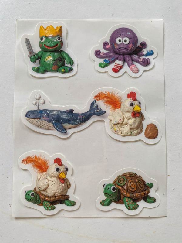 Sticker sheet of six die-cut stickers: the crowned frog, the octopus in socks, the blue whale, the chicken, a turtle, and the chicken riding a turtle.